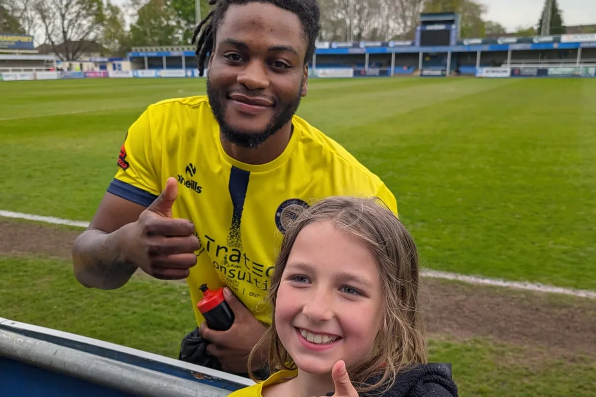 Thumbs up with a Farnborough FC first-team player at the hoardings after the match