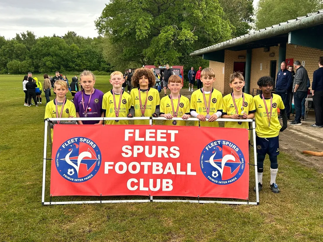 A squad lined up with their medals at the Fleet Spurs tournament.