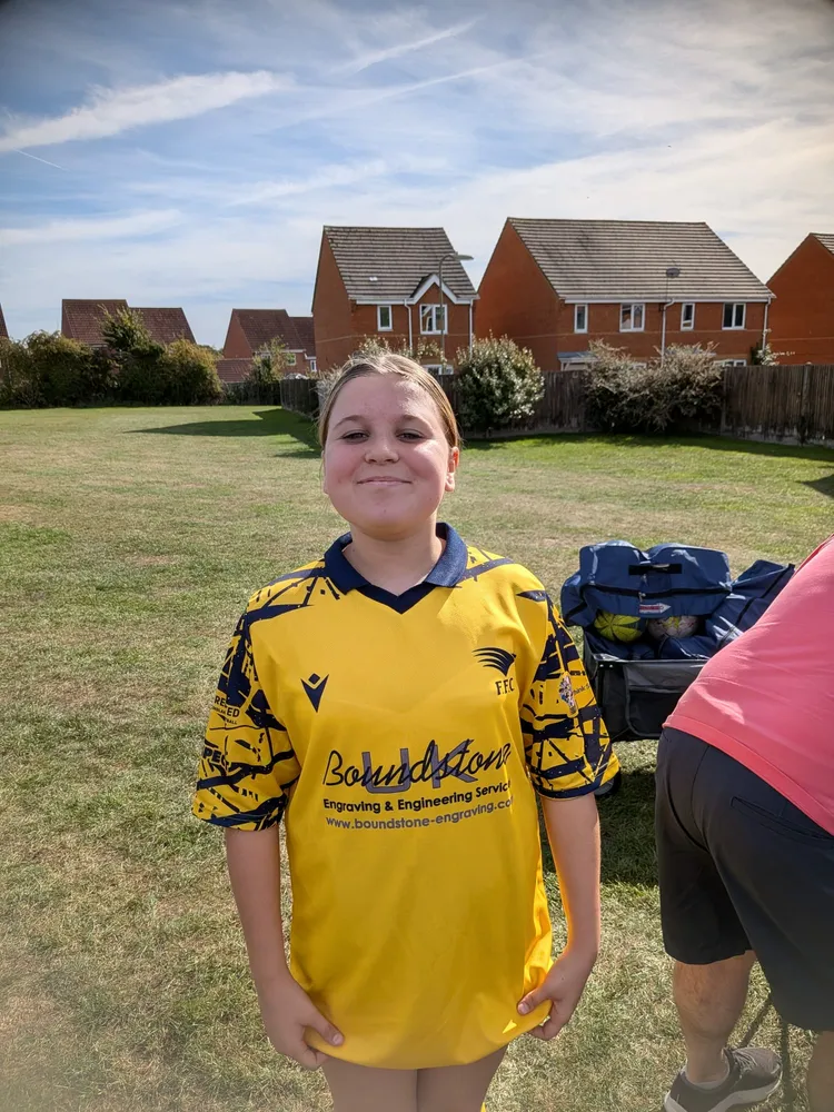 In the yellow home kit after the match, kit bag and match balls behind