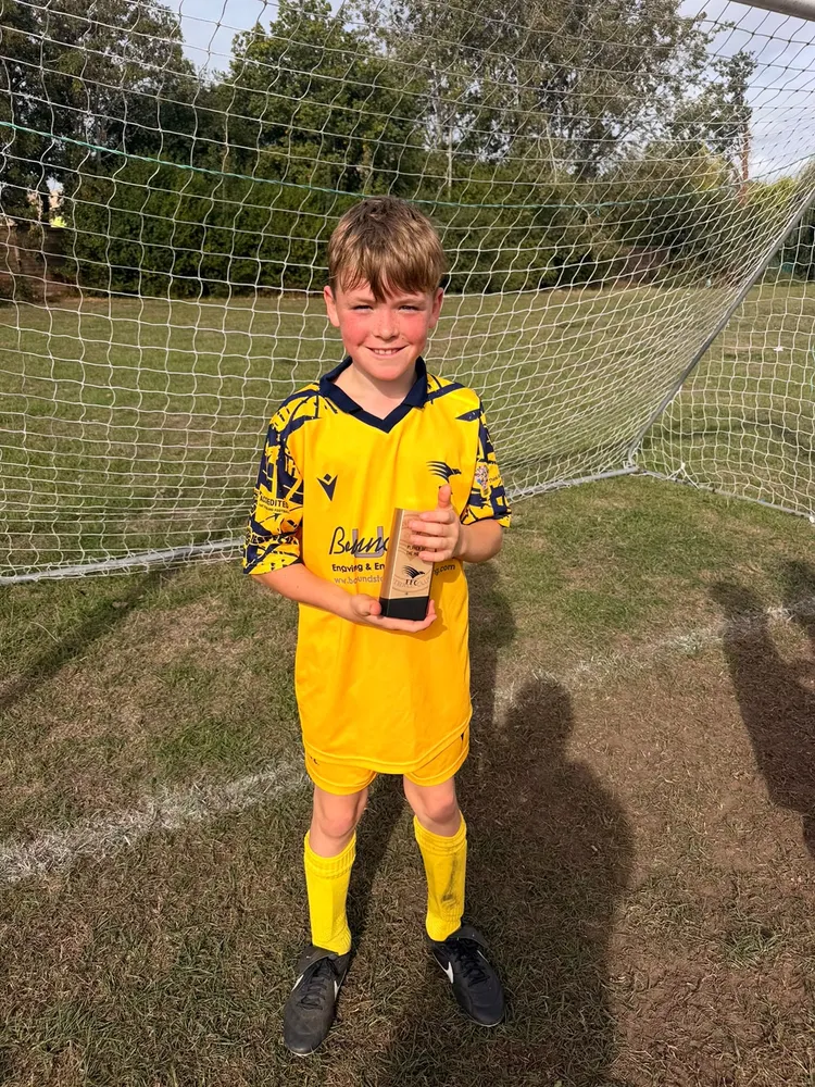 Beaming in front of the net with the trophy cradled in both hands