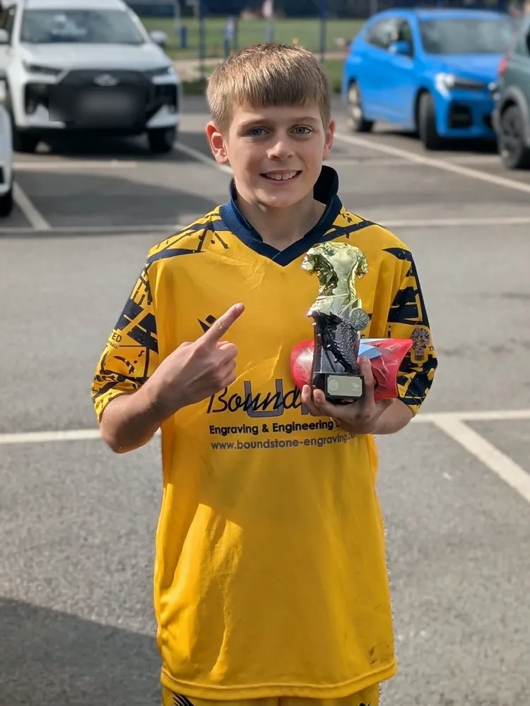 A finger pointed proudly at the shirt in the car park, a gold trophy in the other hand